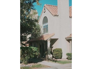Charming home exterior featuring a red tile roof and landscaped front entrance at 5704 E Aire Libre Ave # 1038, Scottsdale, AZ 85254