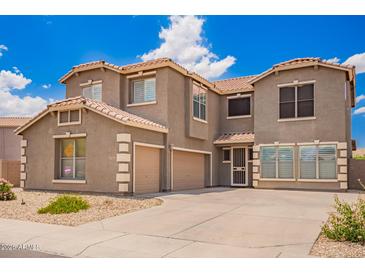 Beautiful two-story home with a three-car garage, well-manicured lawn, and charming curb appeal at 6118 S 46Th Ave, Laveen, AZ 85339