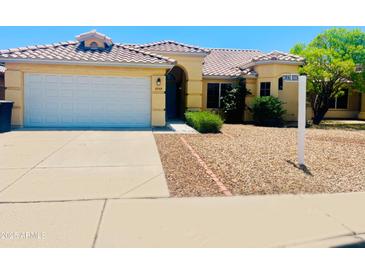 Inviting single-Gathering home featuring a well-maintained front yard and attached two-car garage at 8569 W Fullam St, Peoria, AZ 85382