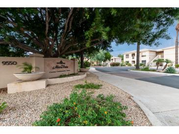 Inviting view of the Mira Vista Luxury Condominium Homes complex entrance with beautiful landscaping and mature trees at 9550 E Thunderbird Rd # 152, Scottsdale, AZ 85260
