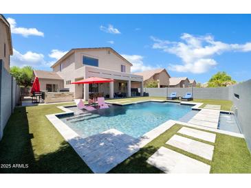 Backyard pool area featuring lounge chairs and an outdoor dining space under a covered patio at 10430 W Los Gatos Dr, Peoria, AZ 85383
