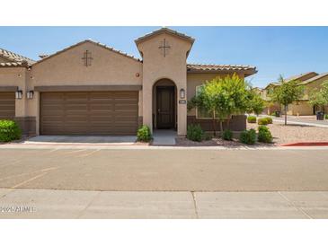 Inviting beige two-story home featuring a tile roof, two-car garage, and well-maintained landscaping at 1255 N Arizona Ave # 1300, Chandler, AZ 85225
