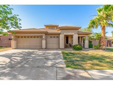 Charming single-story home featuring a three-car garage and a well-manicured front yard at 1474 E Locust Dr, Chandler, AZ 85286
