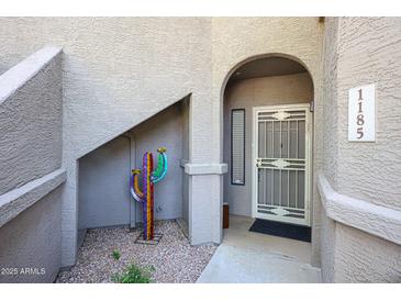 Inviting front entrance with decorative cactus and security door at 15225 N 100Th St # 1185, Scottsdale, AZ 85260