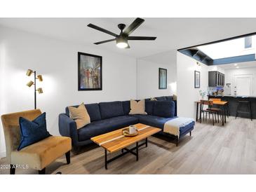 Cozy living room featuring a comfortable blue sofa, stylish decor, and bright lighting at 2946 N 14Th St # 37, Phoenix, AZ 85014