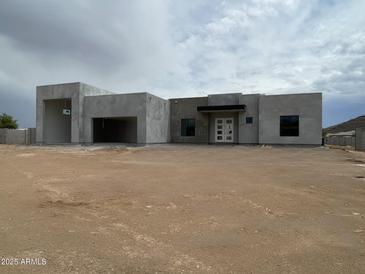 Modern exterior of home featuring unique gray stucco and a large covered entryway at 3283 W Mesquite St, Phoenix, AZ 85086