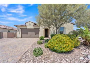 Charming single-story home with a two-car garage, desert landscaping, and a welcoming front entrance at 4866 N 185-Th Dr, Goodyear, AZ 85395