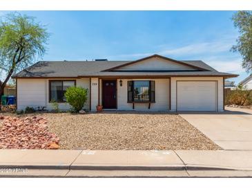Charming single-level home featuring a low-maintenance desert landscape and a two-car garage at 733 E Halifax St, Mesa, AZ 85203