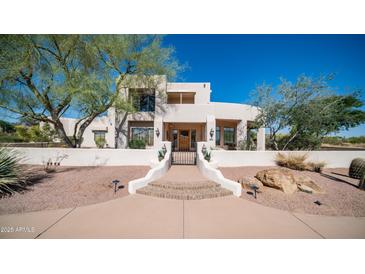 Stunning two-story home featuring desert landscaping, stucco exterior, and a private gated entryway at 8540 E Mcdowell Rd # 116, Mesa, AZ 85207