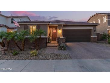 Charming single-story home featuring a well-kept yard, private front gate, and a two-car garage at 17866 W Lilac St, Goodyear, AZ 85338