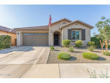 Charming single-story home with manicured landscaping, neutral stucco, and a welcoming front porch at 22920 E Indiana Ave, Queen Creek, AZ 85142