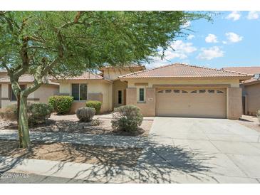 Charming single-story home featuring a tile roof and a well-maintained front yard with mature landscaping at 3310 W Chambers St, Phoenix, AZ 85041