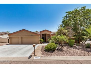 Charming single-story home with a three-car garage and desert landscaping at 4345 E Annette Dr, Phoenix, AZ 85032