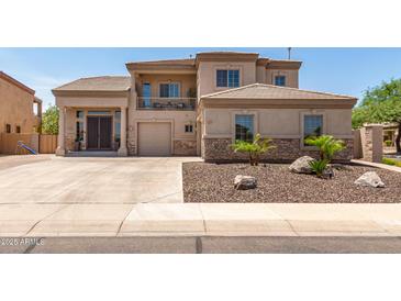 Stunning two-story home featuring a desert landscape, balcony, and spacious driveway at 4423 W Lodge Dr, Laveen, AZ 85339