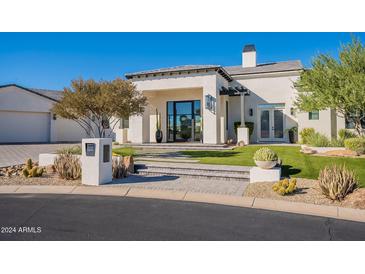 Elegant stucco home featuring a landscaped front yard and a welcoming entrance with modern design elements at 11250 W Prospector Dr, Queen Creek, AZ 85144
