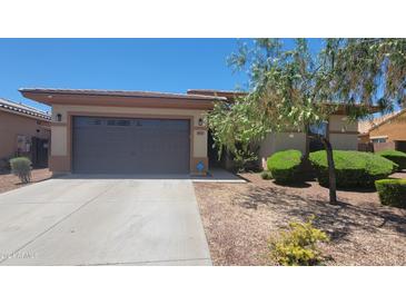 Single-story home with a two-car garage and desert landscaping at 18617 W Williams St, Goodyear, AZ 85338