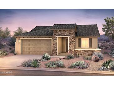Charming single-story home showcasing stone accents, a two-car garage, and desert landscaping at 18683 N 268Th Ave, Buckeye, AZ 85396