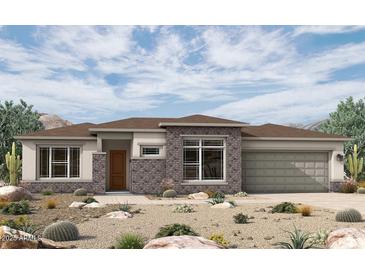 Stunning single-story home with desert landscaping and a brick-accented facade at 20633 W Berridge Ln, Buckeye, AZ 85396
