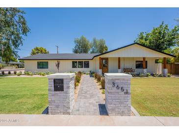 Charming single-story home with a walkway and well-maintained lawn at 3651 N 49Th Pl, Phoenix, AZ 85018