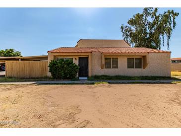 Cozy home featuring a classic tiled roof and a simple, welcoming facade at 4814 W Rose Ln, Glendale, AZ 85301