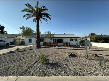 Charming single-story home with desert landscaping and a mature palm tree in the front yard at 1930 W Missouri Ave, Phoenix, AZ 85015