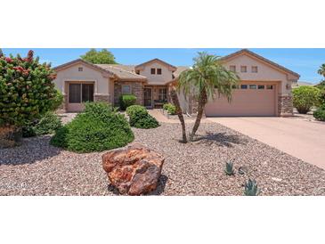 Charming single-story home with landscaped front yard and stone accents at 19662 N Overton Ct, Surprise, AZ 85374