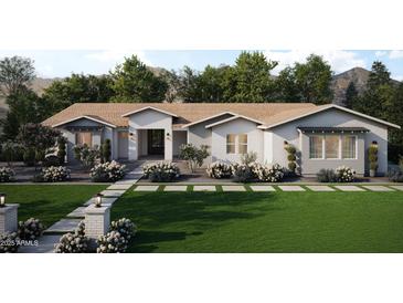 Beautiful one-story home featuring a manicured lawn, white exterior, and welcoming front porch at 1969 E Long Rifle Rd, Phoenix, AZ 85086