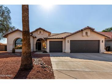 Charming home with a tile roof, low-maintenance landscaping, and a two-car garage at 2716 N Kristen --, Mesa, AZ 85213