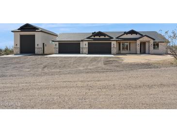 Beautiful single Gathering home featuring a neutral color scheme, three-car garage, and desert landscaping at 31652 N Misty Ln, Queen Creek, AZ 85142