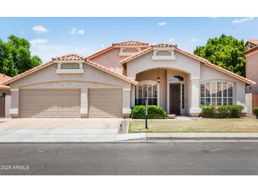 Inviting single-story home showcasing a desert landscape, a two-car garage and beautiful architectural details at 4684 W Tyson St, Chandler, AZ 85226