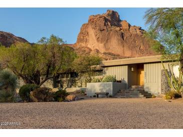 Stunning single-story home featuring desert landscaping with mountain views in the background at 5331 E Mcdonald Dr, Paradise Valley, AZ 85253