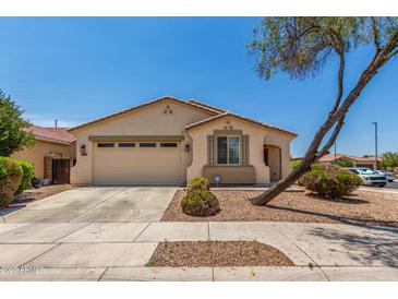 Charming single-story home featuring a two-car garage, desert landscaping, and a beige stucco facade under a sunny blue sky at 17649 W Buchanan St, Goodyear, AZ 85338