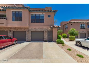 Beautiful townhome with a two-car garage, stone accents, and well-maintained landscaping at 20660 N 40Th St # 2124, Phoenix, AZ 85050