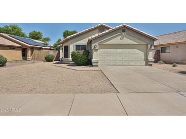 Charming single-story home featuring a two-car garage, low maintenance desert landscaping, and a neutral color palette at 21833 N 34Th Ave, Phoenix, AZ 85027