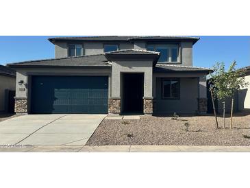 Charming two-story home with a two-car garage and well-maintained front yard with desert landscaping at 25360 W Bowker St, Buckeye, AZ 85326
