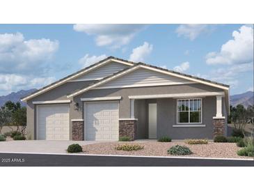 Charming single-story home featuring a symmetrical facade, dual garages, and stone accents, creating an inviting curb appeal at 2654 E Rustler Rd, San Tan Valley, AZ 85140
