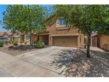Charming two-story home with a well-manicured front yard and a two-car garage at 4380 W White Canyon Rd, San Tan Valley, AZ 85144
