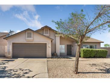 Charming single-Gathering home with a two-car garage and low-maintenance desert landscaping at 10702 W Orangewood Ave, Glendale, AZ 85307