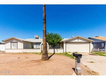 Modest single story home with a front yard and a desert landscape at 1602 N 73Rd Dr, Phoenix, AZ 85035