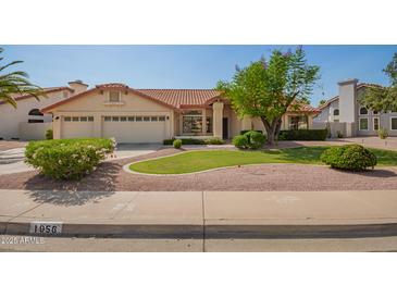 Charming home with a three-car garage, lush lawn, mature trees, and desert landscaping at 1956 E Calle De Caballos --, Tempe, AZ 85284