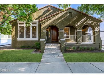 Charming home with arched porch, manicured lawn, and welcoming curb appeal at 2743 E Virginia St, Gilbert, AZ 85296