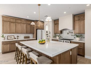 Spacious kitchen with marble countertops, an island with seating and modern fixtures at 2743 E Virginia St, Gilbert, AZ 85296