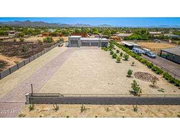 Expansive aerial view showcasing the property's large lot with desert landscaping and detached garage at 38415 N 25Th Ave, Phoenix, AZ 85086
