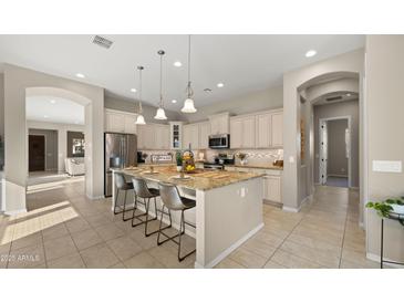 Bright eat-in kitchen featuring stainless steel appliances, granite countertops, and a large kitchen island at 4341 E Evelyn St, Gilbert, AZ 85295