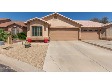 Inviting single-story home featuring a two-car garage and low-maintenance desert landscaping at 6610 E University Dr # 2, Mesa, AZ 85205