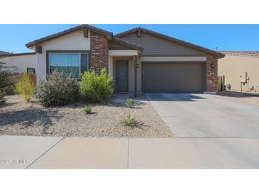 Charming single-story home featuring a two-car garage and low-maintenance desert landscaping at 10964 W Garfield St, Avondale, AZ 85323