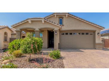 Charming single-story home featuring a well-manicured front yard and a two-car garage at 15078 W Mckinley St, Goodyear, AZ 85338
