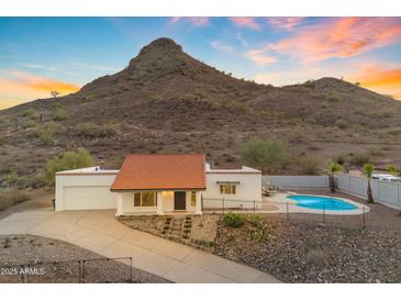 Charming single-story home with a red tile roof, mountain views, and a backyard pool at 1917 E Karen Dr, Phoenix, AZ 85022