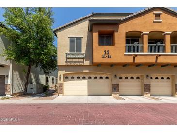 Charming townhome with a two-car garage and a well-maintained exterior with beautiful architectural details at 2727 N Price Rd # 32, Chandler, AZ 85224