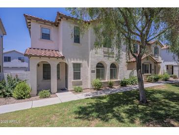 Charming two-story townhome with desert landscaping, arched entryways and tile roof at 3451 S Wren Dr, Gilbert, AZ 85297
